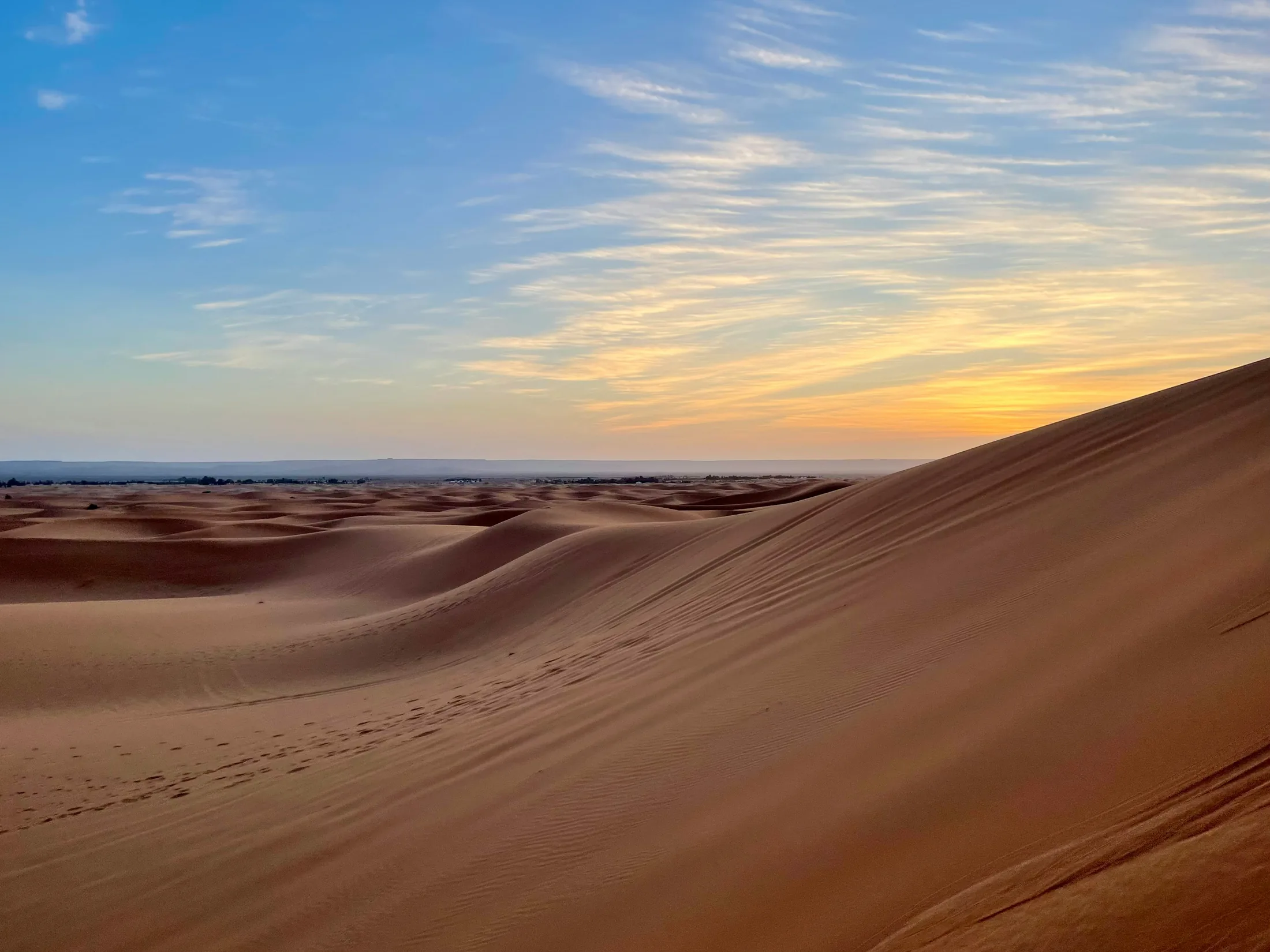 Rolling sand dunes in Morocco at sunset